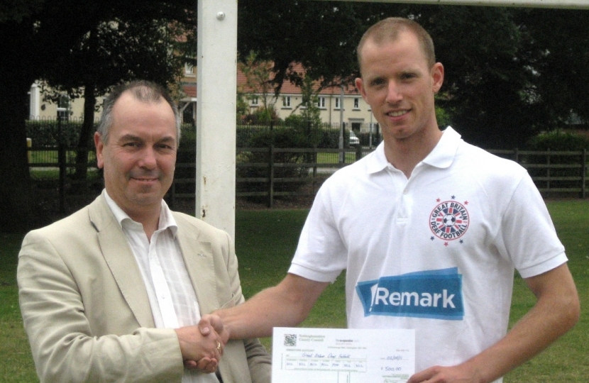 Cllr Eric Kerry presenting Jeremy Millensted with his CDF sponsorship cheque