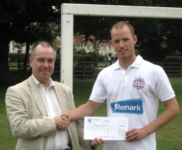 Cllr Eric Kerry presenting Jeremy Millensted with his CDF sponsorship cheque